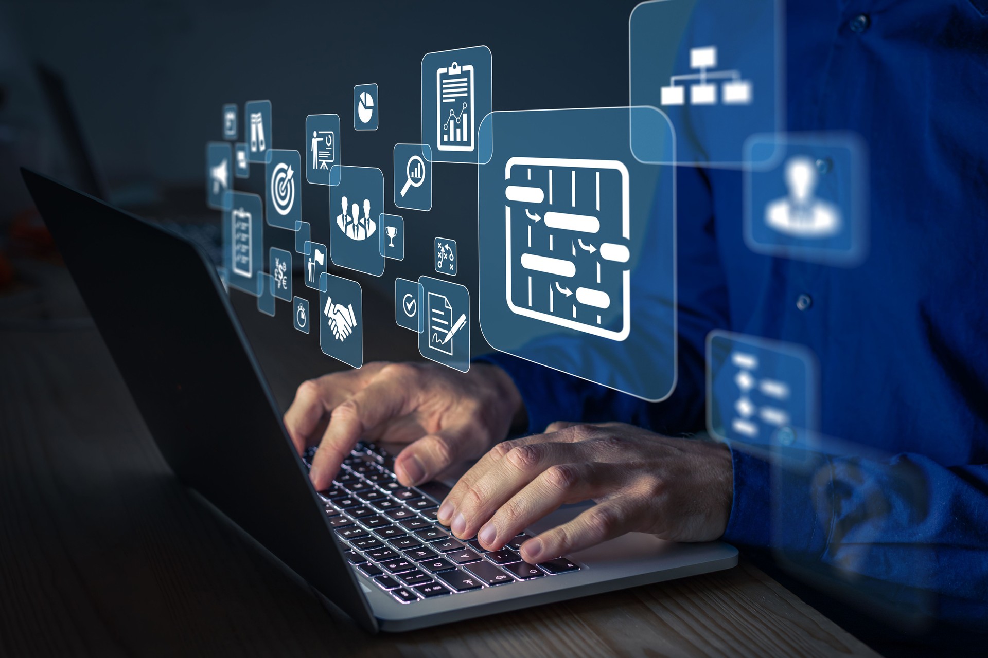 Project manager working on computer at the office. Concept with icons of management areas such as cost, planning, risks, schedule. Person typing on keyboard.